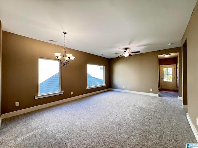 unfurnished room featuring ceiling fan with notable chandelier and carpet flooring