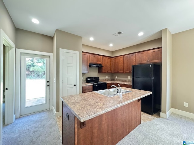 kitchen with an island with sink, black appliances, sink, and light colored carpet