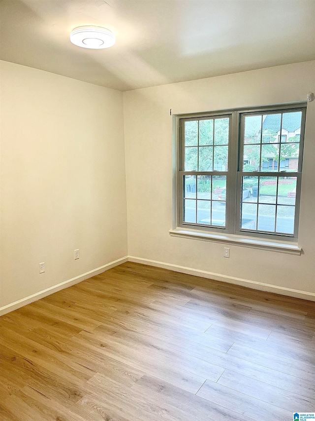 spare room with light hardwood / wood-style flooring