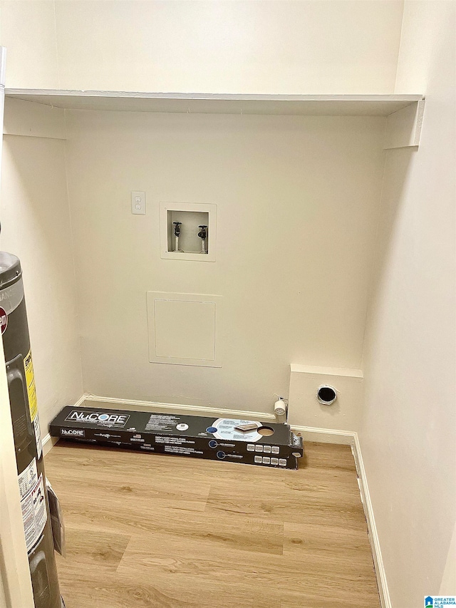 laundry room with hookup for an electric dryer, water heater, hookup for a washing machine, and hardwood / wood-style floors