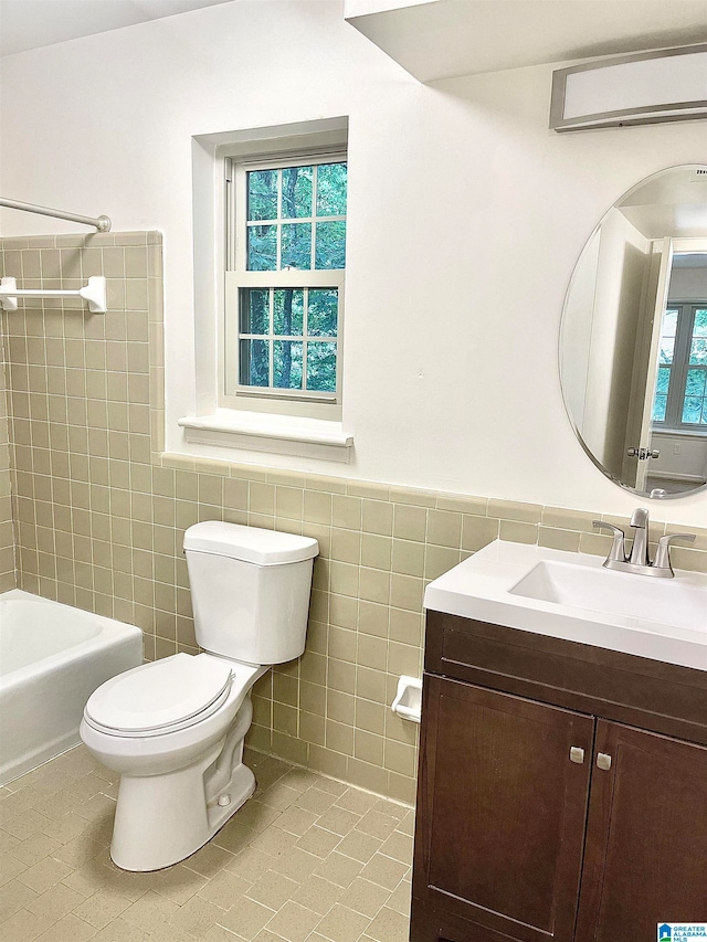 full bathroom with vanity, tile walls, tile patterned flooring, and toilet