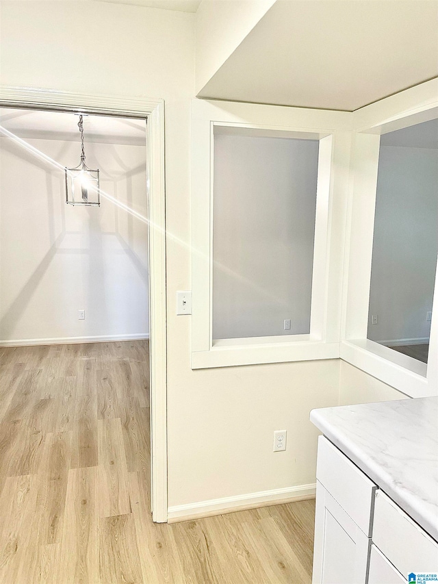 walk in closet featuring light hardwood / wood-style flooring