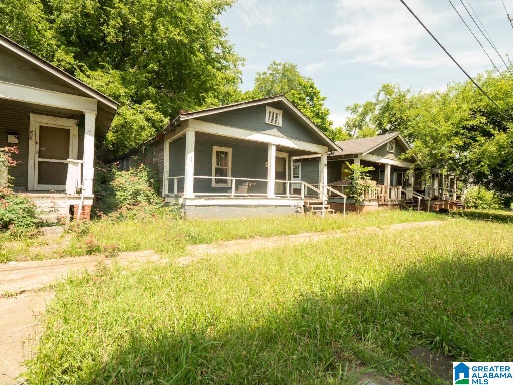 rear view of house featuring a lawn