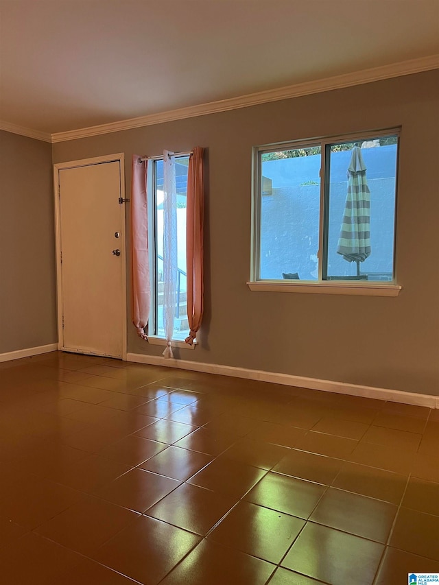 foyer entrance featuring ornamental molding and dark tile patterned flooring