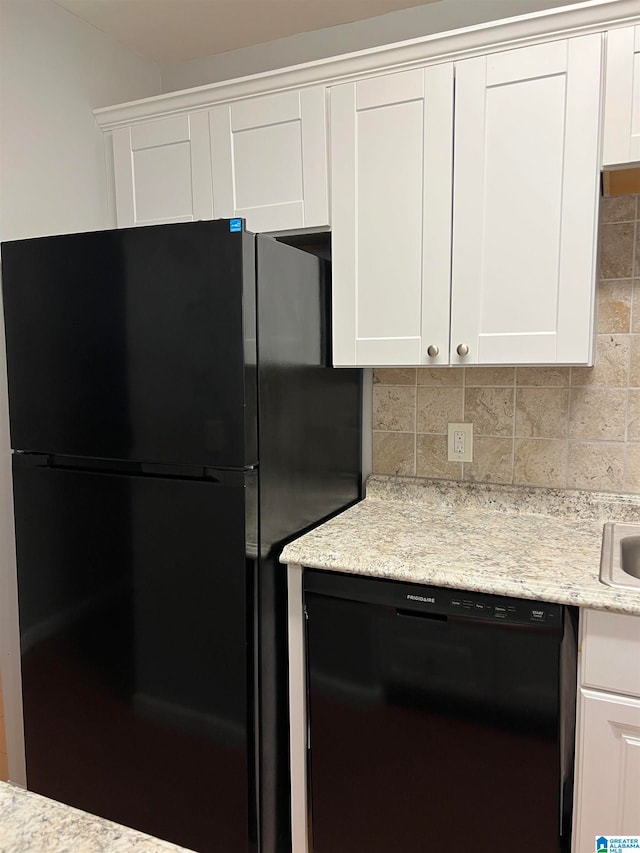 kitchen featuring white cabinets, black appliances, and backsplash