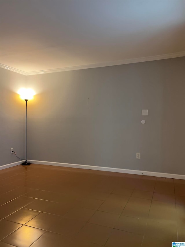 spare room with ornamental molding and tile patterned flooring