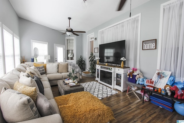 living room featuring dark wood finished floors and ceiling fan