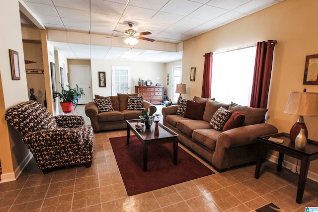 living room with ceiling fan and tile patterned flooring