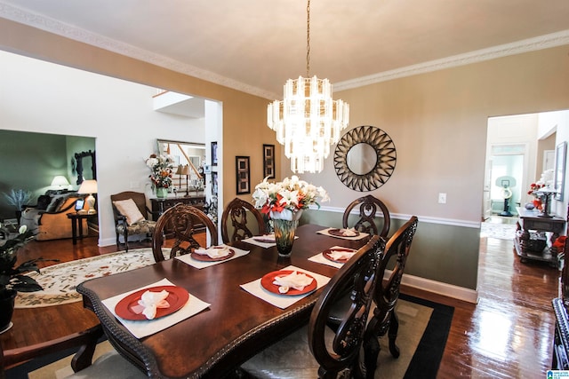 dining area featuring ornamental molding, a chandelier, and dark hardwood / wood-style floors