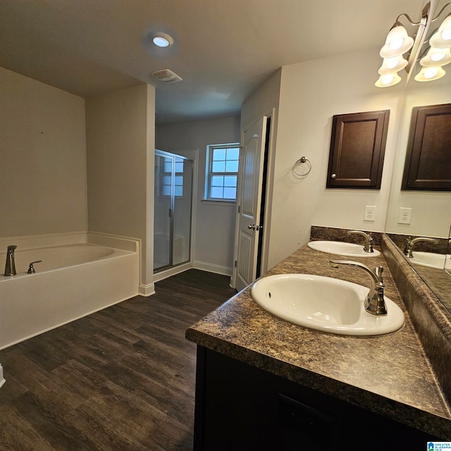 bathroom with shower with separate bathtub, hardwood / wood-style flooring, and vanity