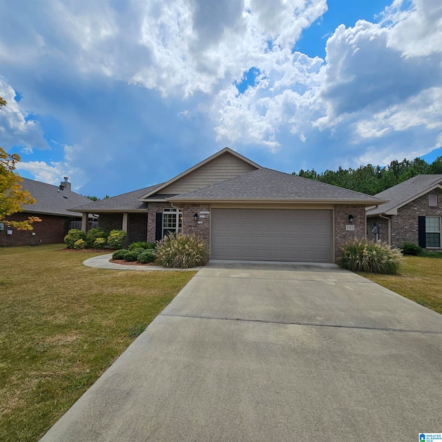 single story home featuring a garage and a front lawn