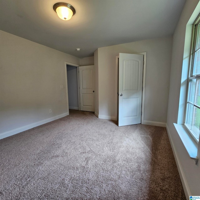 unfurnished bedroom featuring light colored carpet