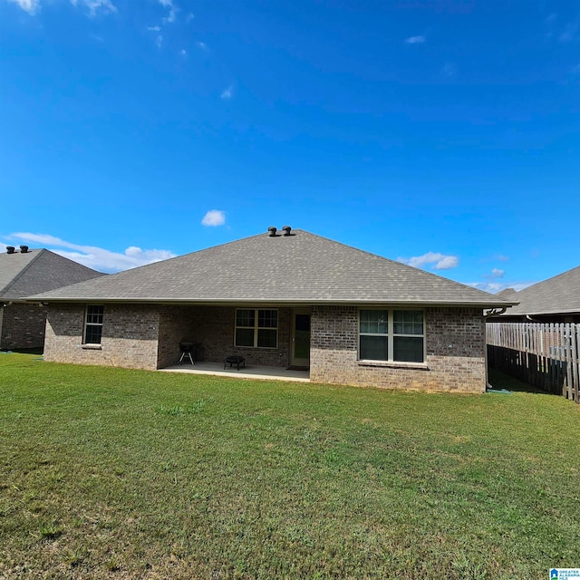 rear view of property with a patio area and a yard