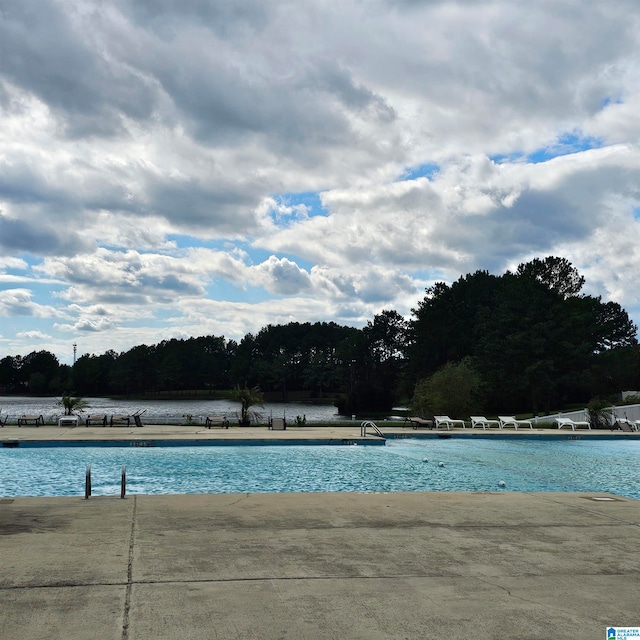 view of pool with a water view