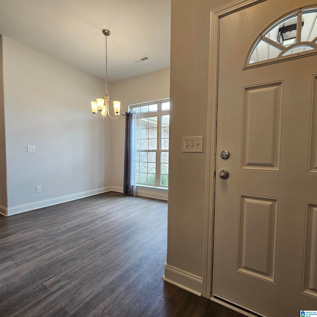 entrance foyer with an inviting chandelier and dark wood-type flooring