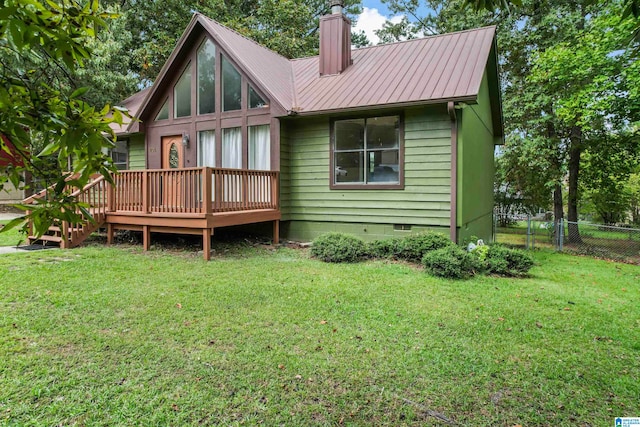 back of property with a lawn and a wooden deck