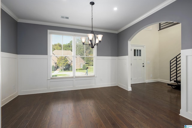 unfurnished dining area featuring a chandelier, dark hardwood / wood-style floors, and ornamental molding