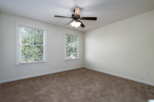 carpeted empty room featuring ceiling fan and a healthy amount of sunlight