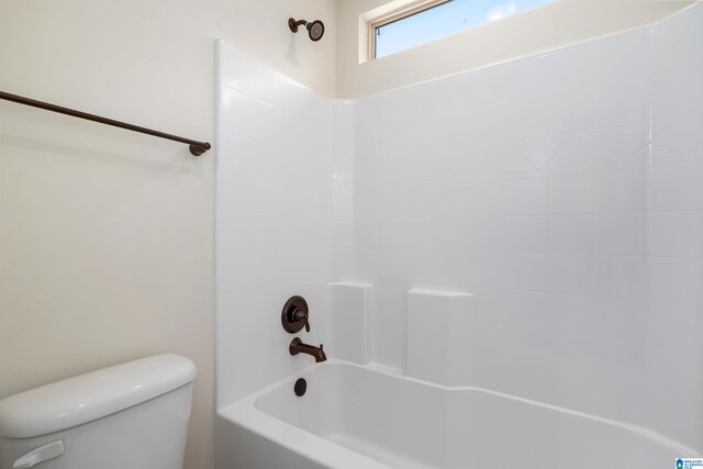 bathroom with shower / bath combination and toilet