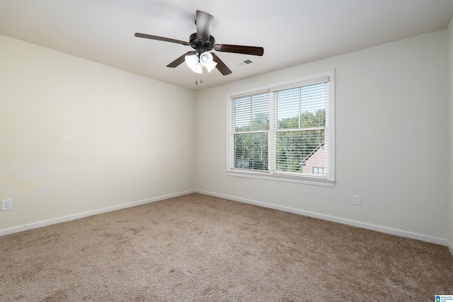 carpeted spare room featuring ceiling fan