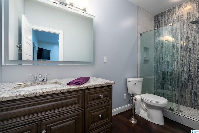 bathroom with vanity, toilet, wood-type flooring, and walk in shower