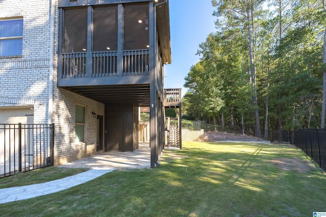 back of house featuring a sunroom and a yard