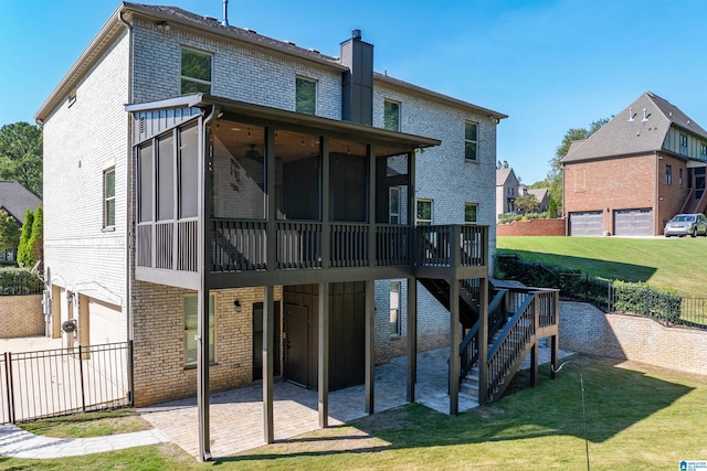 back of house with a yard, a patio, a garage, and a sunroom