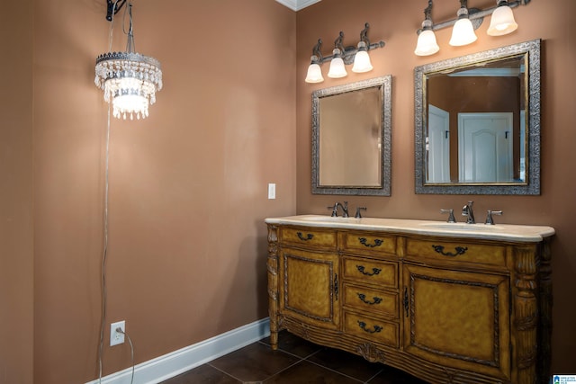 bathroom featuring a notable chandelier, ornamental molding, vanity, and tile patterned floors