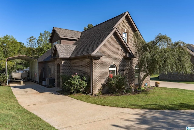 view of side of home featuring a yard and central AC