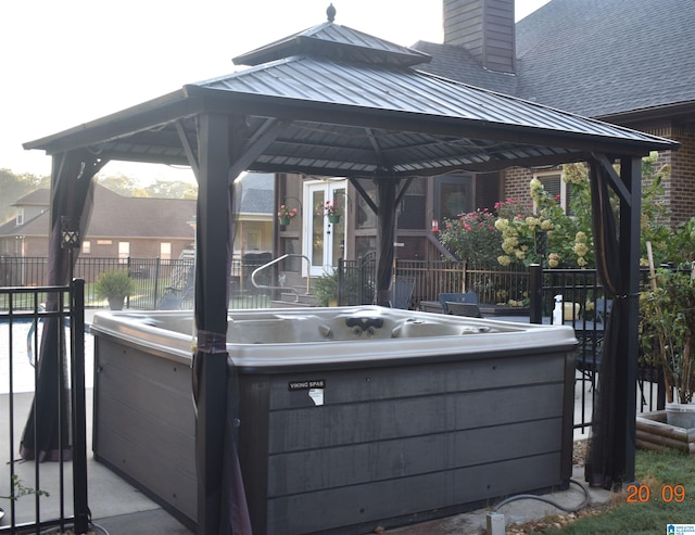 view of patio / terrace featuring a gazebo and a hot tub