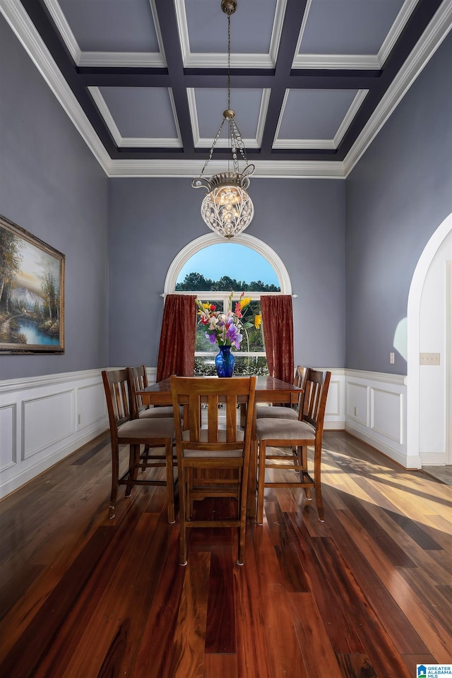 dining area featuring coffered ceiling, dark hardwood / wood-style flooring, crown molding, beam ceiling, and a chandelier