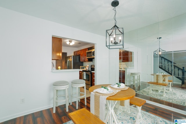 dining room featuring an inviting chandelier and dark hardwood / wood-style floors