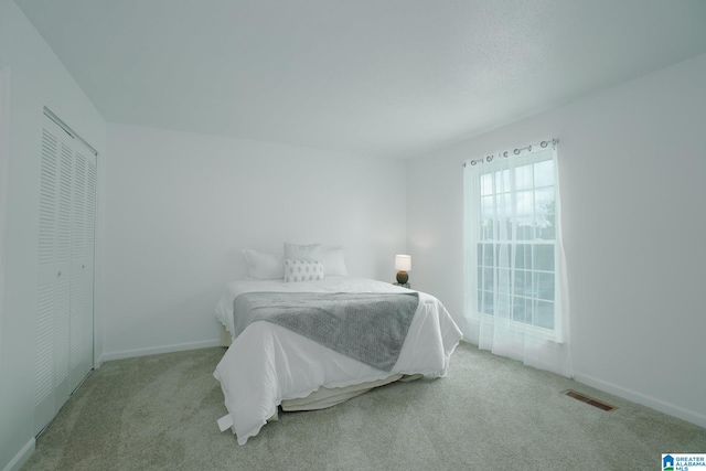 carpeted bedroom featuring a closet