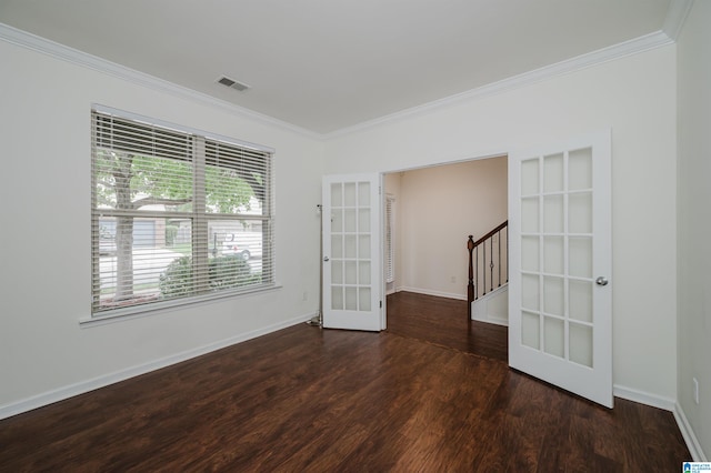 spare room with crown molding, dark hardwood / wood-style flooring, and french doors