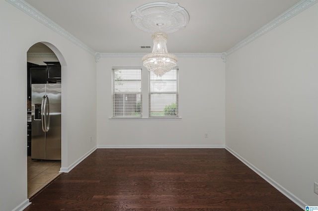 unfurnished dining area featuring ornamental molding, dark wood-type flooring, and a chandelier