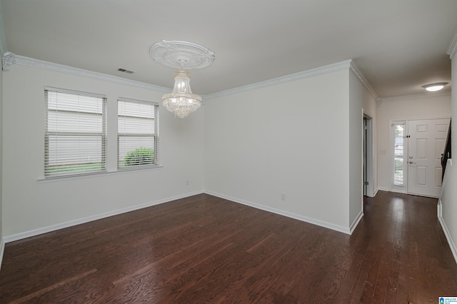 unfurnished room with ornamental molding, a chandelier, and dark hardwood / wood-style flooring