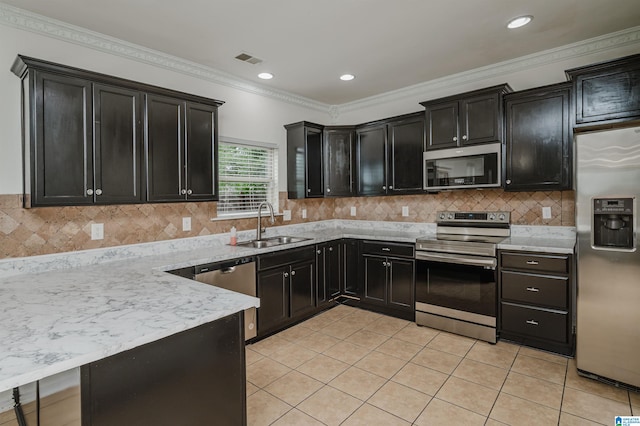 kitchen featuring sink, crown molding, light tile patterned floors, appliances with stainless steel finishes, and decorative backsplash