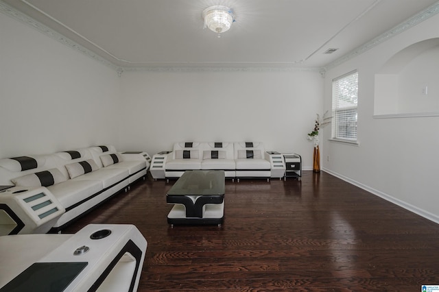 living room with dark hardwood / wood-style flooring and ornamental molding