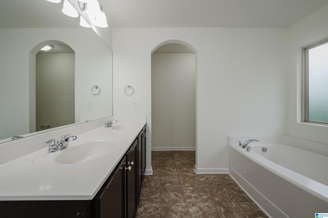 bathroom featuring vanity and a tub