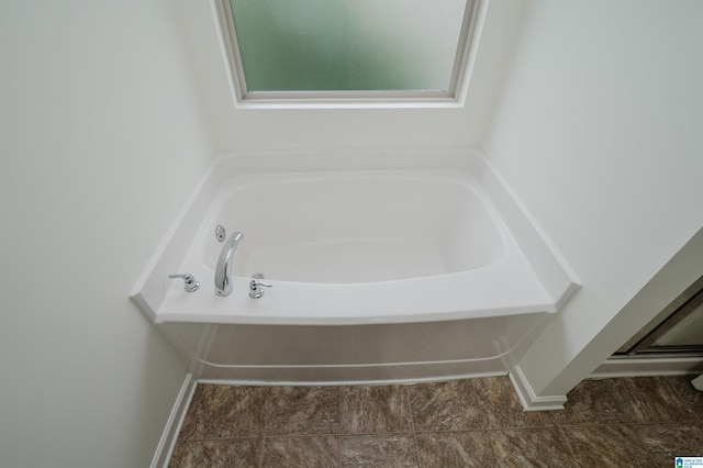 bathroom with a tub to relax in