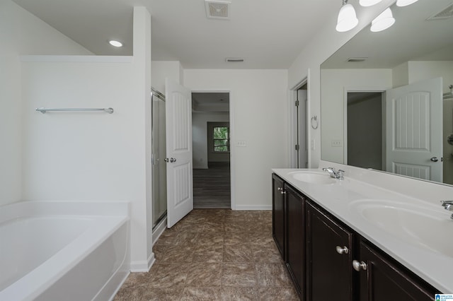 bathroom featuring vanity and independent shower and bath