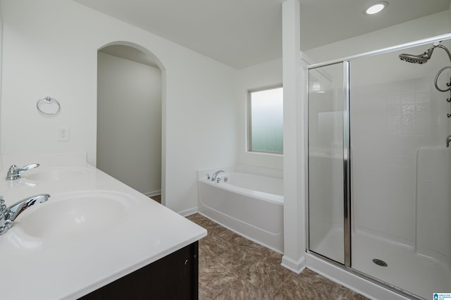 bathroom with shower with separate bathtub and vanity