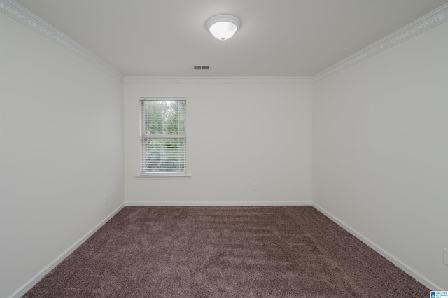 empty room featuring dark carpet and crown molding