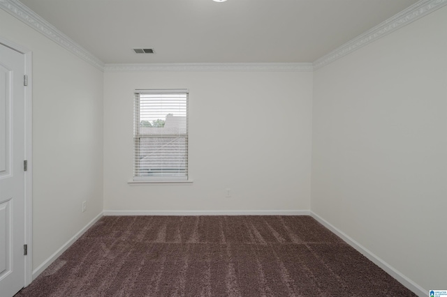 carpeted spare room featuring crown molding