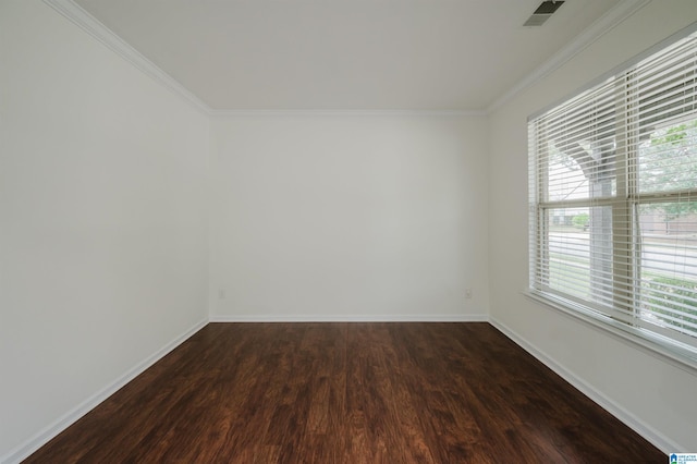 spare room featuring crown molding and dark wood-type flooring