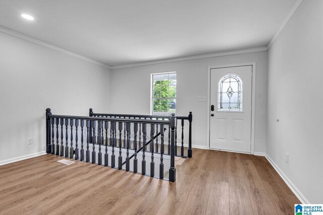 unfurnished room with light wood-type flooring, ceiling fan, and crown molding