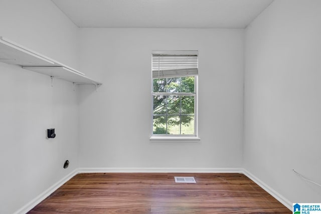 laundry area with wood-type flooring and hookup for an electric dryer