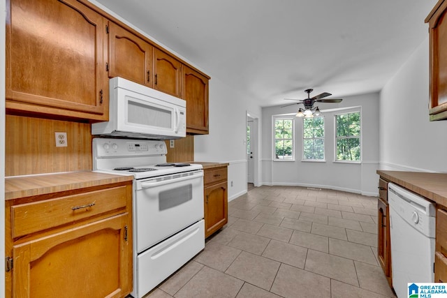 kitchen featuring light tile patterned floors, white appliances, and ceiling fan