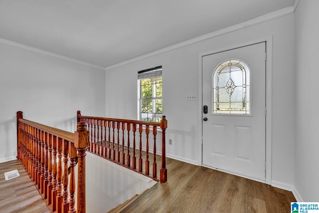 foyer entrance with hardwood / wood-style flooring and ornamental molding