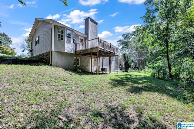 back of house with a yard and a deck